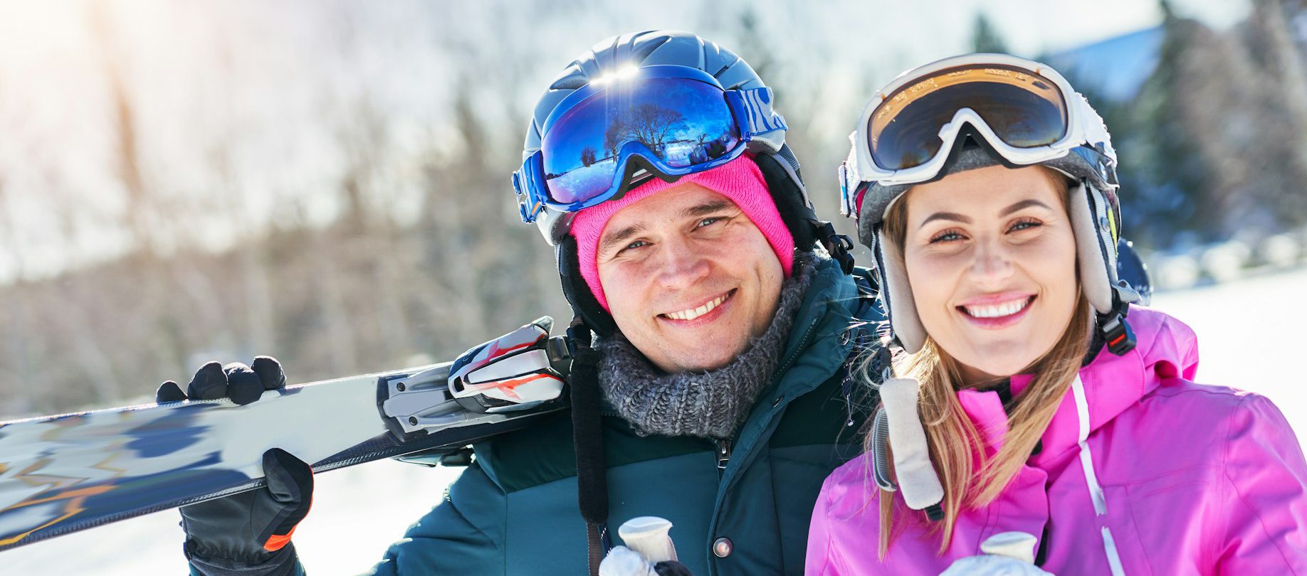 Young couple having fun while winter skiing